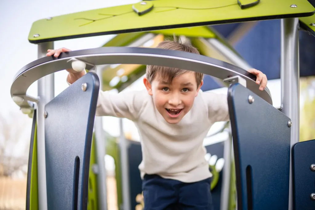 A young child plays in a sensory-friendly playground at Mariposa Autism Service Center.