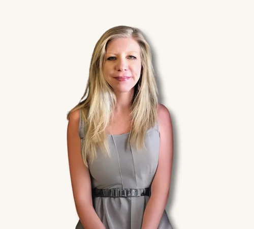 Portrait of Amanda Barela in a gray dress against a light background