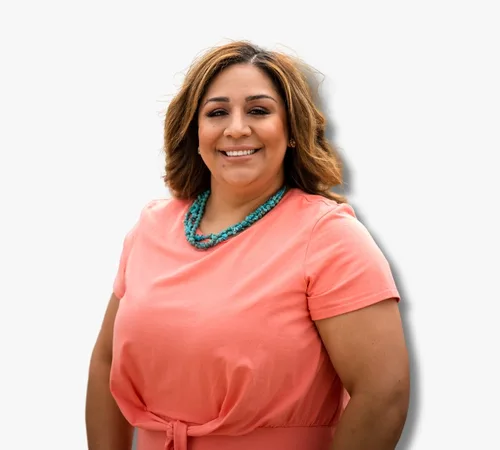 Portrait of Brenda Miranda in a coral dress and turquoise necklace