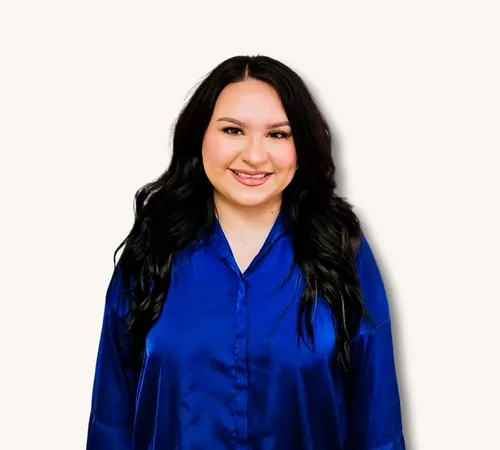 Portrait of Cynthia Perez in a blue blouse against a light background