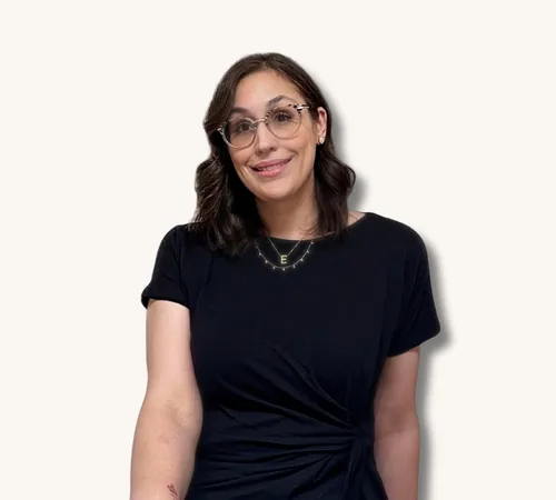 Portrait of Erika Held wearing glasses and a black top against a plain background