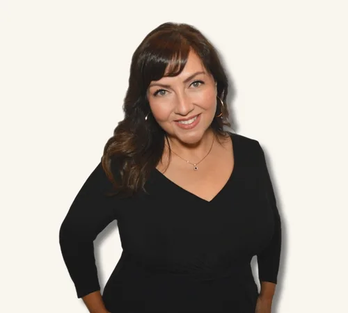 Portrait of Inez Quinones in a black dress against a light background
