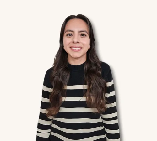 Portrait of Jeanette Coronel in a black-and-white striped sweater against a light background