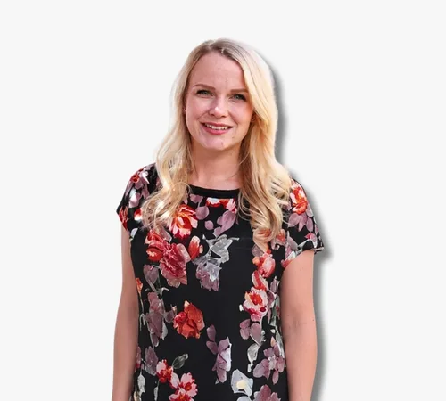 Karah Tooley sonriendo con un vestido floral sobre un fondo blanco