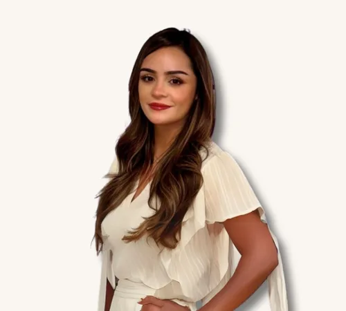 Portrait of Karla Solis-Holguin in a white dress against a plain background