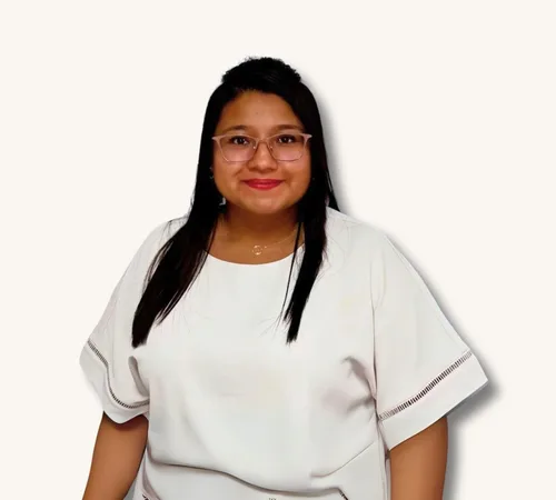 Portrait of Margarita Solis wearing glasses and a white top against a plain background