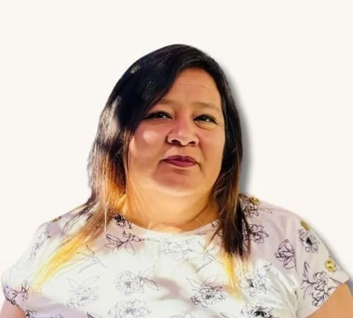 Jessica Betancourt standing in front of a cream background.